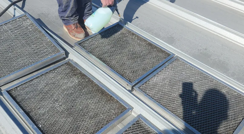people cleaning duct filters