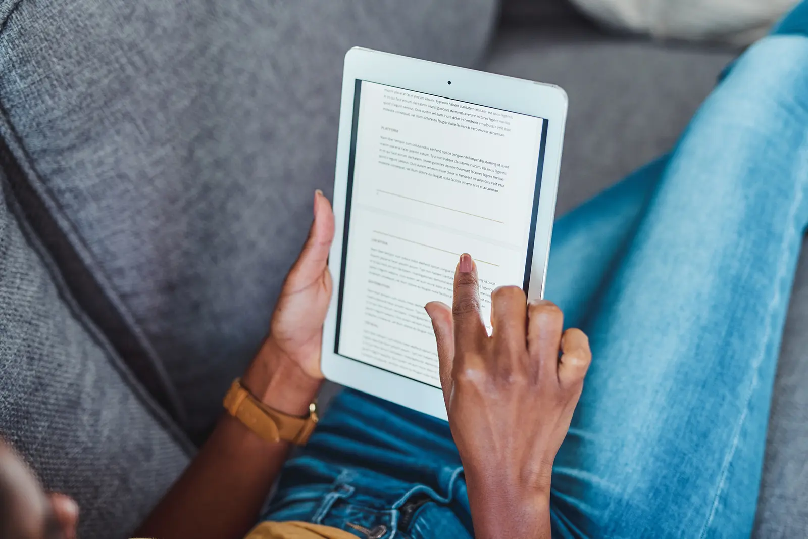 Person using a tablet to read about air conditioner replacement options in Fort Collins, CO, emphasizing the importance of timely upgrades before summer heat.